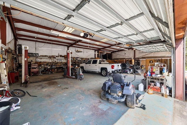 garage with a workshop area and a garage door opener