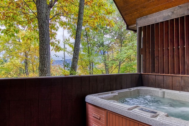 view of patio / terrace featuring a mountain view and a hot tub