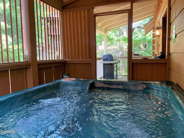 view of pool featuring area for grilling and a hot tub