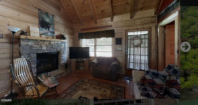 living room with wood ceiling, lofted ceiling with beams, a fireplace, hardwood / wood-style floors, and wood walls