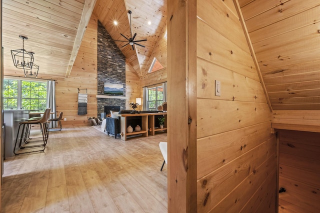 corridor featuring a wealth of natural light, wooden ceiling, high vaulted ceiling, wood walls, and hardwood / wood-style floors