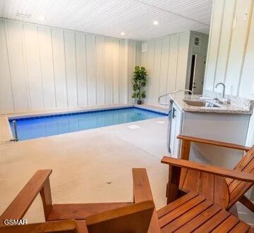 view of swimming pool featuring sink