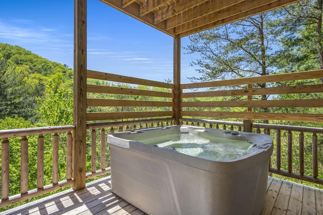 wooden deck featuring a hot tub