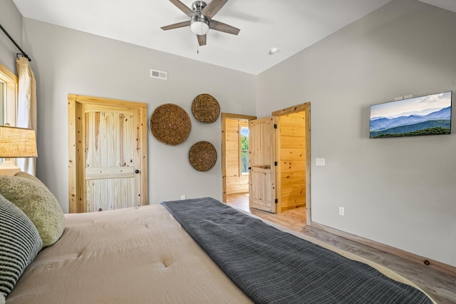 bedroom with ceiling fan, wood-type flooring, and ensuite bathroom