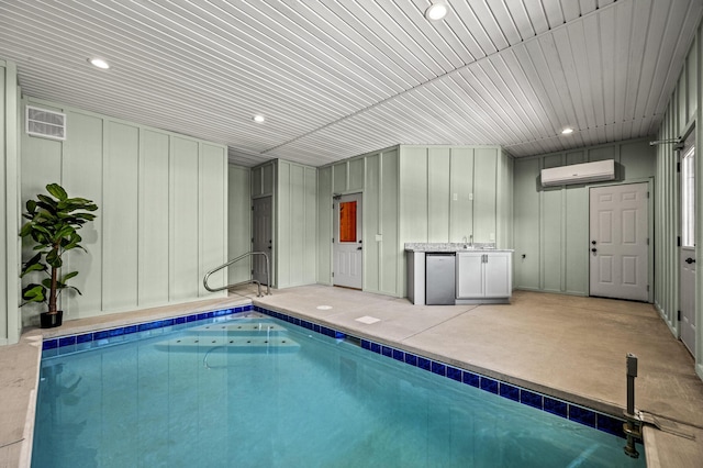 view of swimming pool with a wall mounted air conditioner
