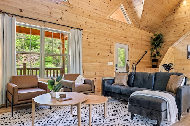 living room with wooden walls, high vaulted ceiling, wooden ceiling, and light wood-type flooring