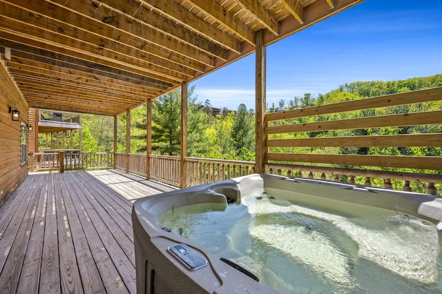 wooden deck featuring a hot tub