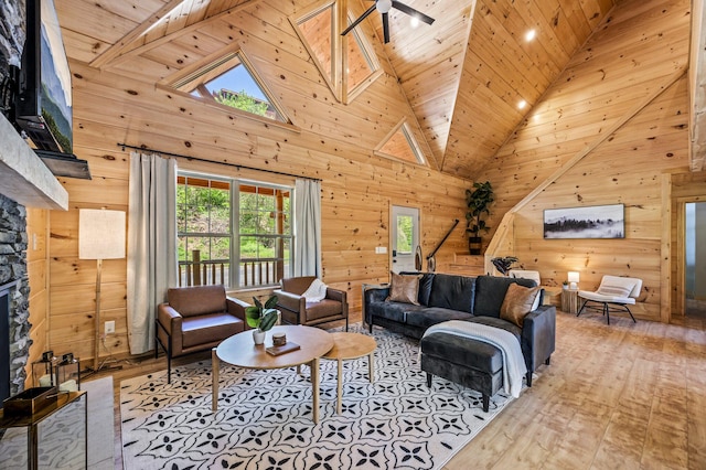 living room with ceiling fan, wooden ceiling, a fireplace, and high vaulted ceiling