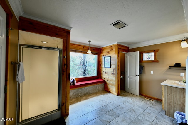 bathroom featuring a textured ceiling, vanity, and ornamental molding