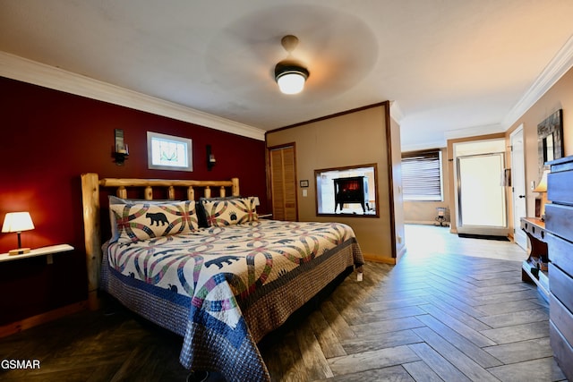 bedroom with dark parquet floors, ceiling fan, ornamental molding, and a closet