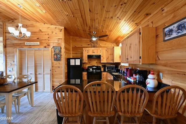 kitchen with ventilation hood, vaulted ceiling, sink, black appliances, and light brown cabinets