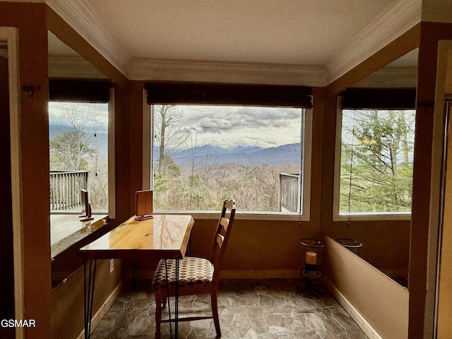 sunroom / solarium featuring a wealth of natural light and a mountain view