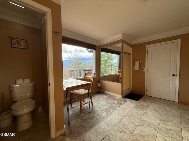 bathroom featuring toilet and ornamental molding