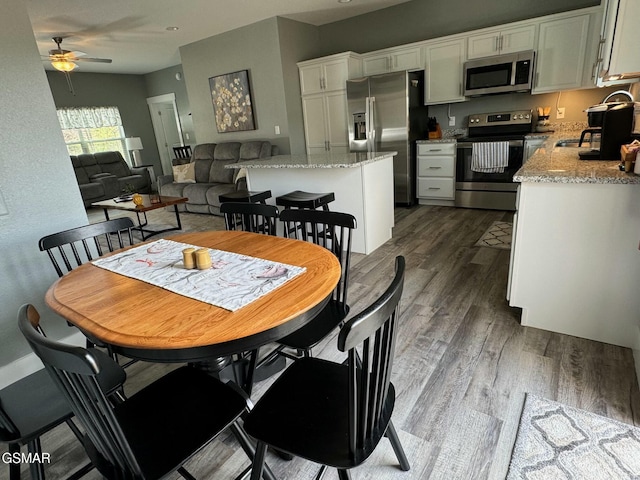 dining area featuring wood finished floors and ceiling fan