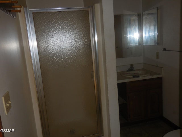 bathroom with vanity and a shower with shower door