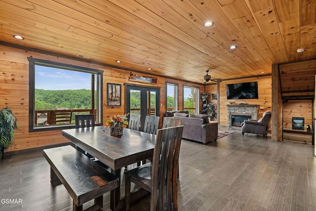 4541 Shangrila Way, Sevierville, TN 37876 - dining room with a stone fireplace, wood walls, wood finished floors, and wooden ceiling