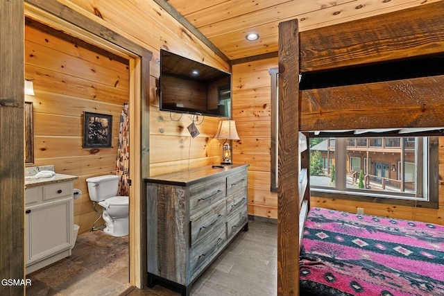 4541 Shangrila Way, Sevierville, TN 37876 - bedroom featuring wooden ceiling, wood walls, and connected bathroom