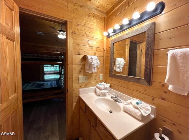 311 Caney Creek Rd, Pigeon Forge, TN 37863 - bathroom featuring wood walls, vanity, wood finished floors, and a ceiling fan