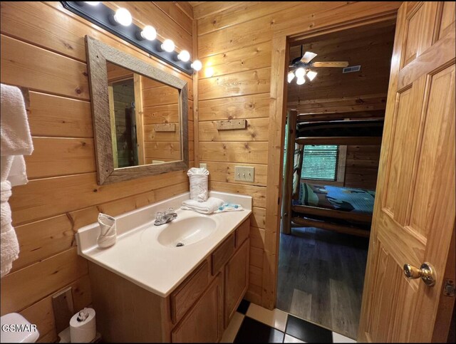 311 Caney Creek Rd, Pigeon Forge, TN 37863 - bathroom featuring wood walls, vanity, and ceiling fan