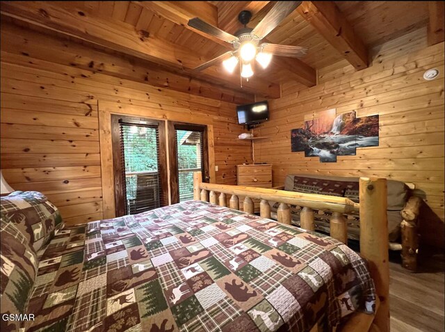 311 Caney Creek Rd, Pigeon Forge, TN 37863 - bedroom featuring wooden walls, a wooden ceiling with exposed beams, and wood finished floors