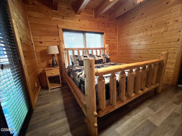 311 Caney Creek Rd, Pigeon Forge, TN 37863 - bedroom with beamed ceiling, wood walls, and wood finished floors