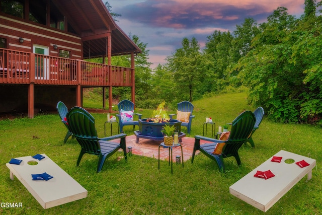 3510 Twin City Way, Pigeon Forge, TN 37863 - yard at dusk featuring a fire pit, a deck, and a lawn