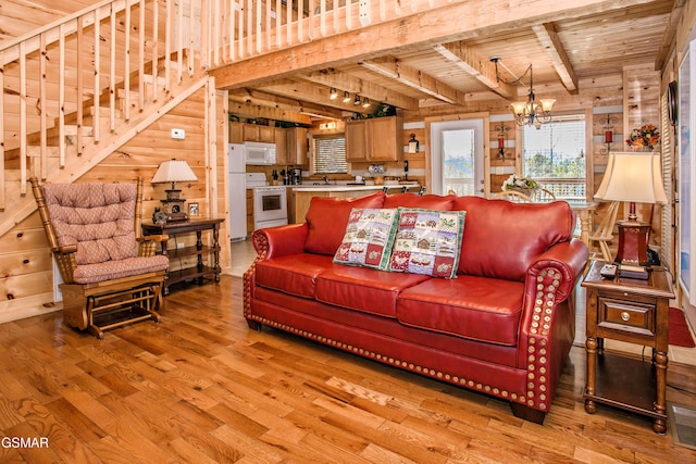 3510 Twin City Way, Pigeon Forge, TN 37863 - living room featuring light wood-style floors, wooden ceiling with exposed beams, a chandelier, stairs, and wooden walls