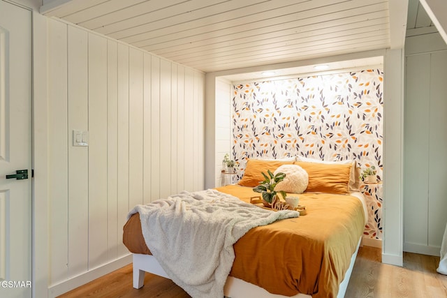 bedroom featuring wood ceiling and light wood-style flooring