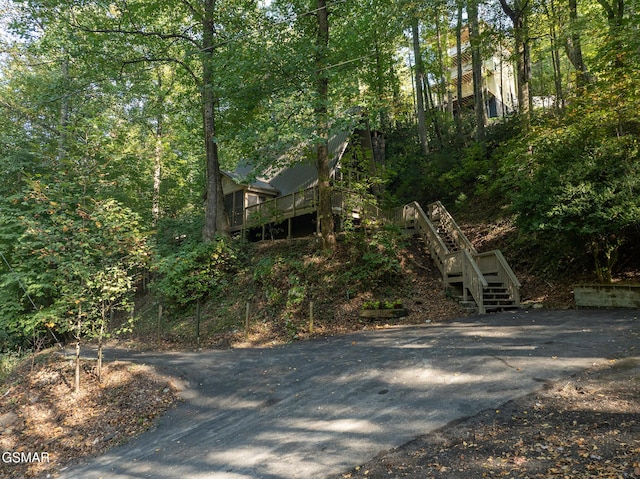 exterior space featuring driveway and stairs