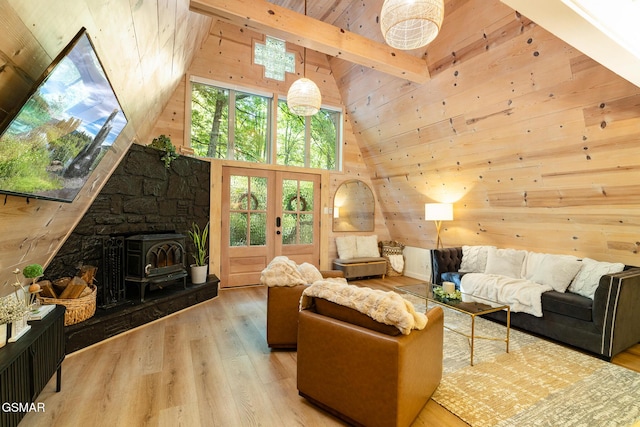 living area with high vaulted ceiling, beamed ceiling, wooden walls, and wood finished floors