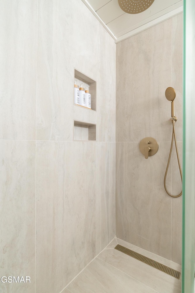 bathroom with tiled shower