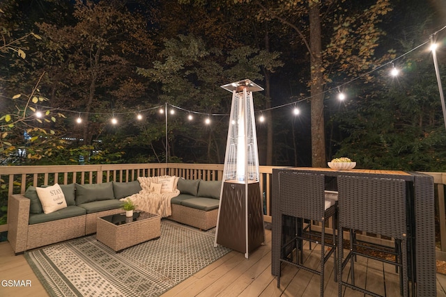 deck at twilight with an outdoor hangout area