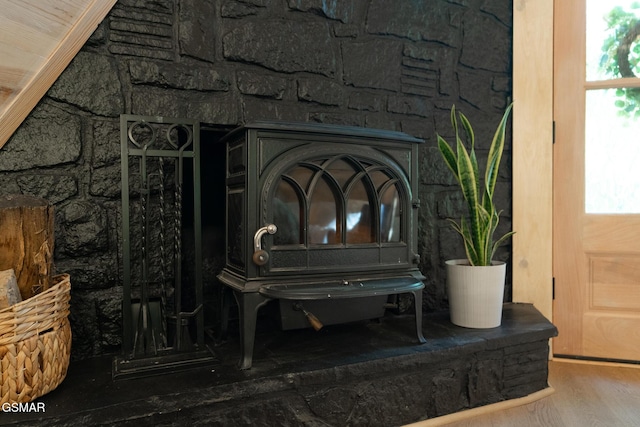 room details featuring wood finished floors and a wood stove