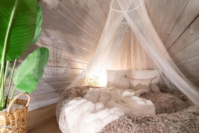 bedroom with lofted ceiling, wood ceiling, wooden walls, and wood finished floors