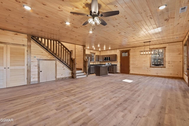 unfurnished living room featuring ceiling fan, wood-type flooring, wooden ceiling, and wooden walls