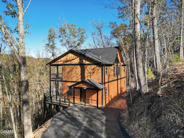 view of front of home featuring central AC unit and a balcony