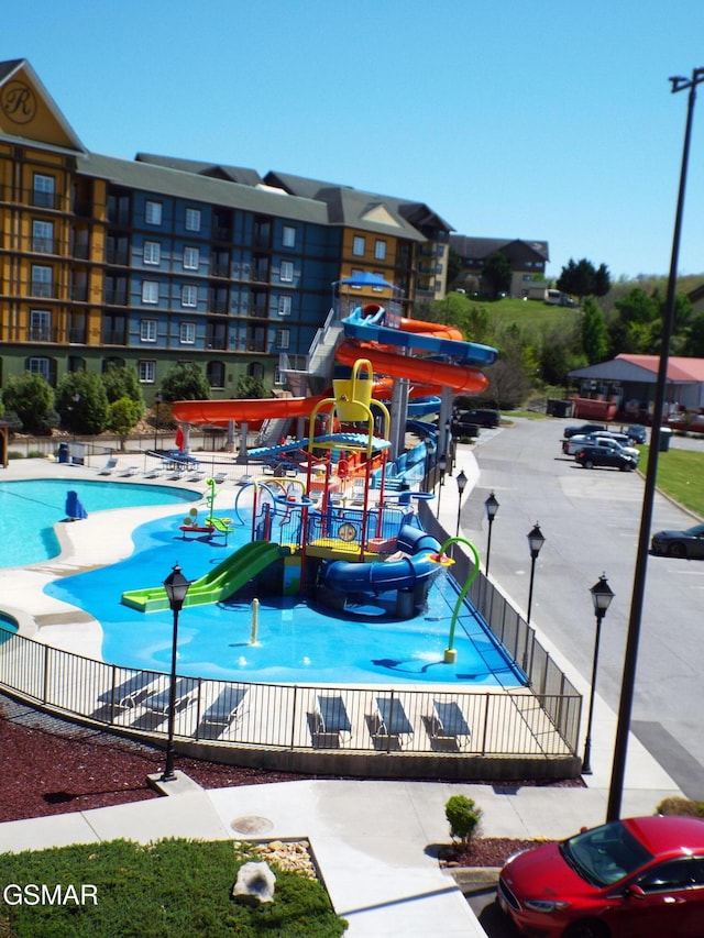 exterior space featuring fence and playground community