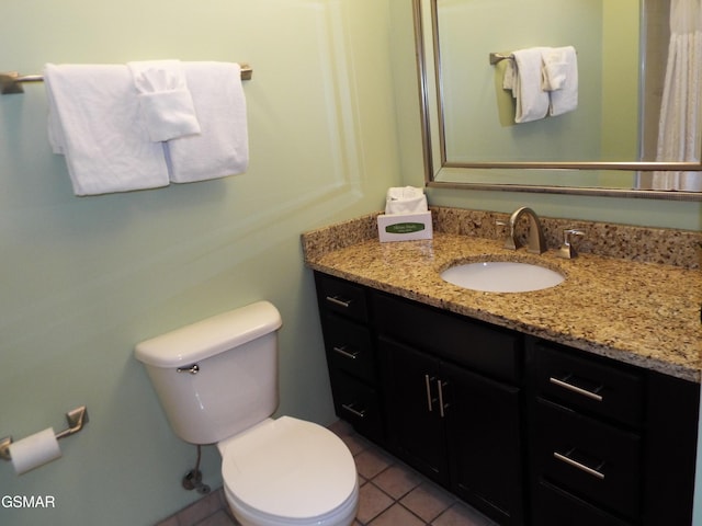 bathroom with toilet, tile patterned floors, and vanity