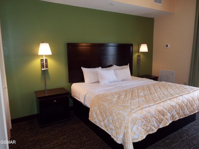 bedroom with baseboards, carpet, and visible vents