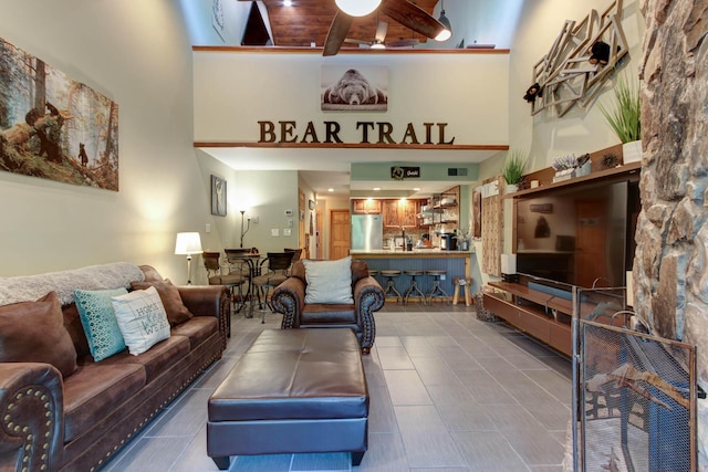 1435 Wiley Oakley Dr Unit 173, Gatlinburg, TN 37738 - living room featuring beam ceiling, a towering ceiling, ceiling fan, and wooden ceiling