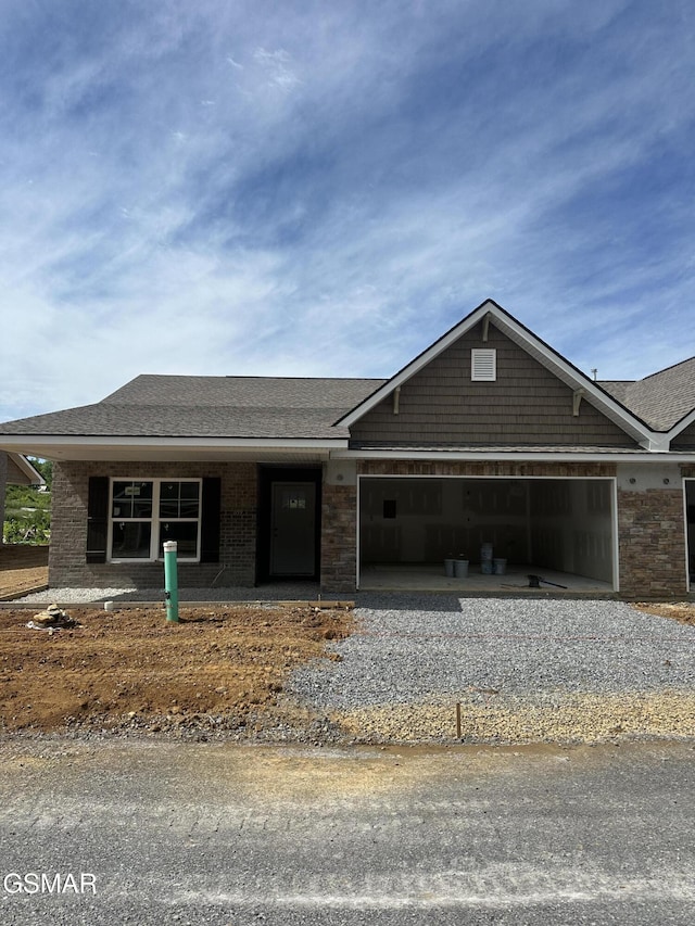 659 Snowflower Cir Unit 143, Pigeon Forge, TN 37863 - view of front of property featuring a garage, driveway, a shingled roof, and covered porch