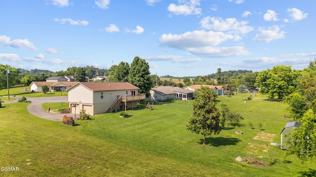 3206 Bativa Garden Ct, Sevierville, TN 37876 - view of green lawn with stairway, driveway, a deck, view of scattered trees, and a garage