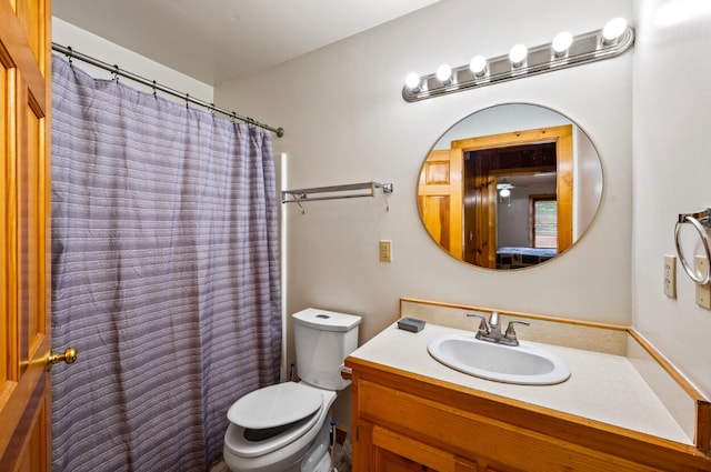 bathroom with vanity, toilet, and walk in shower