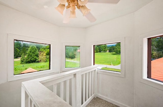 interior space with a wealth of natural light and ceiling fan