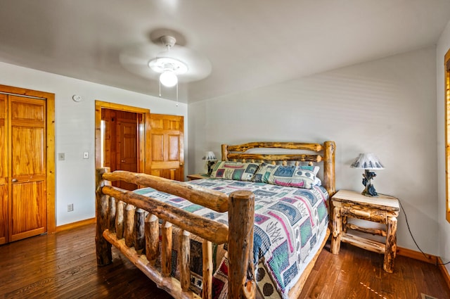 bedroom with ceiling fan and dark hardwood / wood-style flooring