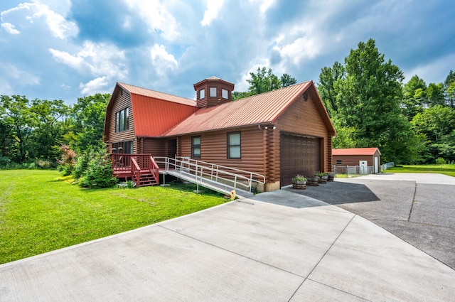 view of front facade featuring a front yard, an outbuilding, a deck, and a garage