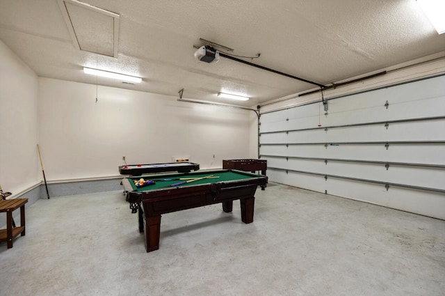 game room featuring a textured ceiling, concrete floors, and pool table