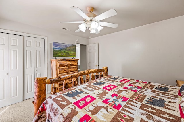 carpeted bedroom featuring ceiling fan and a closet