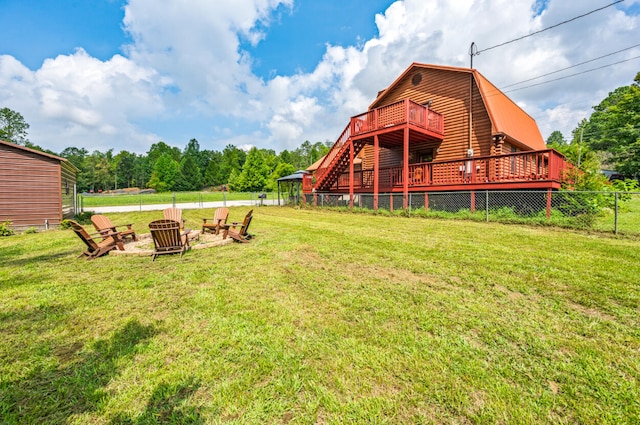 view of yard featuring a fire pit and a deck