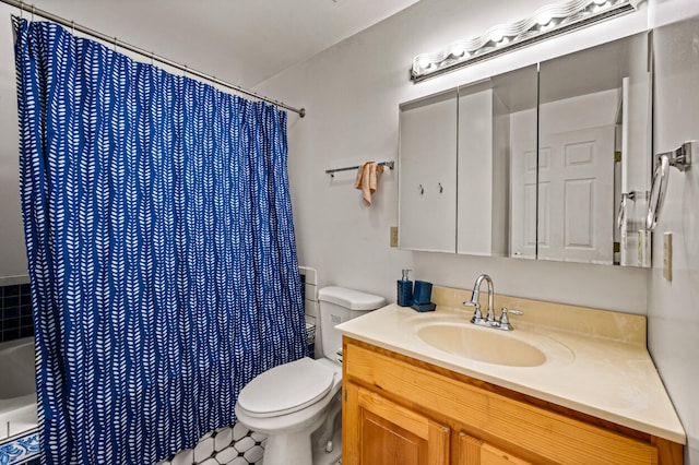 bathroom with tile patterned floors, vanity, and toilet